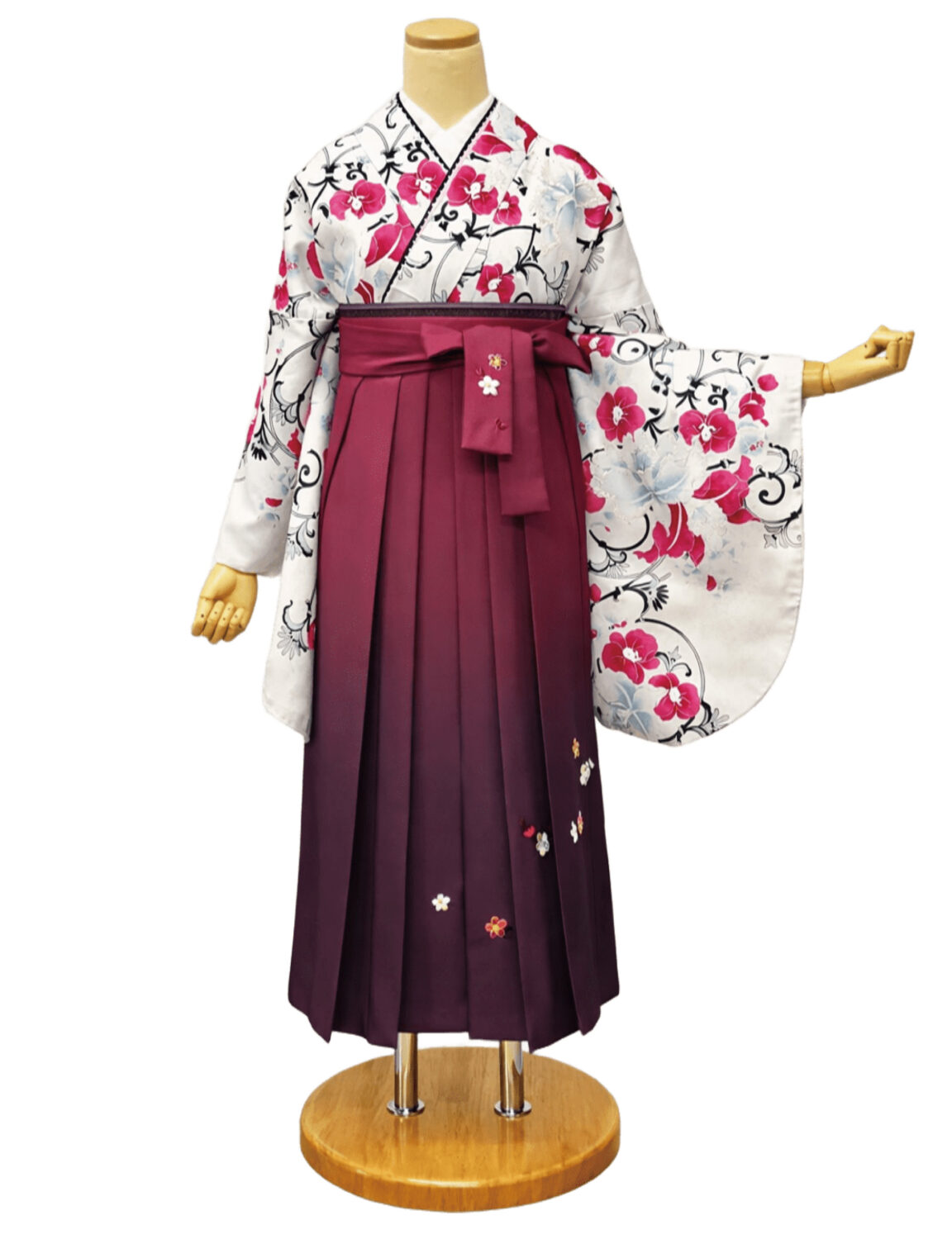 白地に赤と水色の花柄が描かれた着物に、袴を合わせた卒業式の和装姿