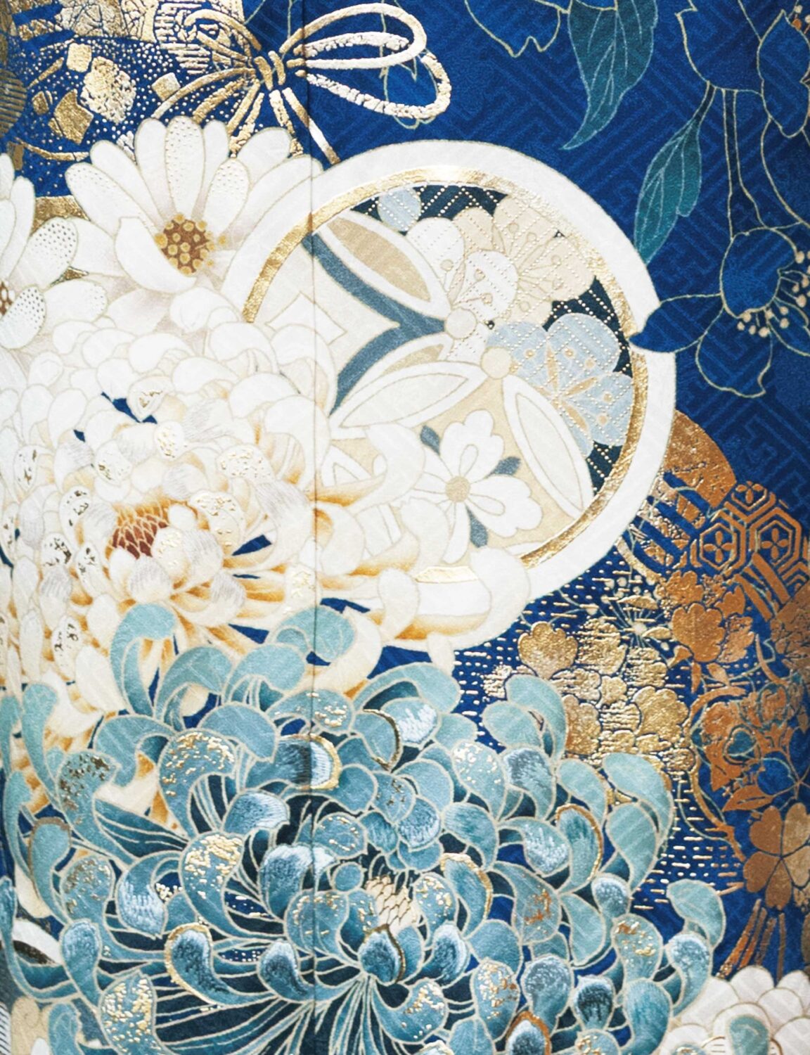 白金の花模様が美しい深藍の振袖を着た女性。気品ある帯締がアクセント。